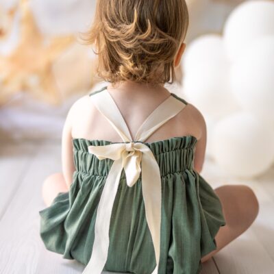 mace and co kids clothing dubai, romper with long bow back in linen material and khaki green colour. Girls ages up to seven years old, including infant and toddler. Perfect for playtime, birthday parties and formal events.