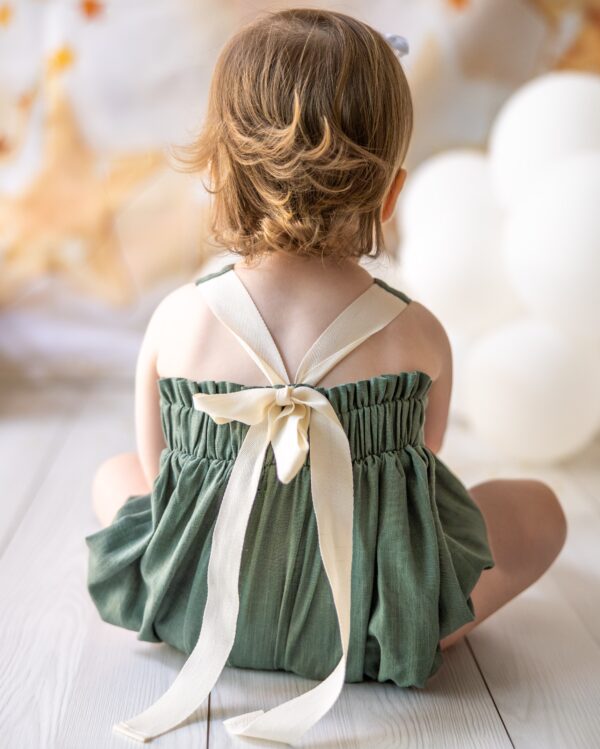 mace and co kids clothing dubai, romper with long bow back in linen material and khaki green colour. Girls ages up to seven years old, including infant and toddler. Perfect for playtime, birthday parties and formal events.